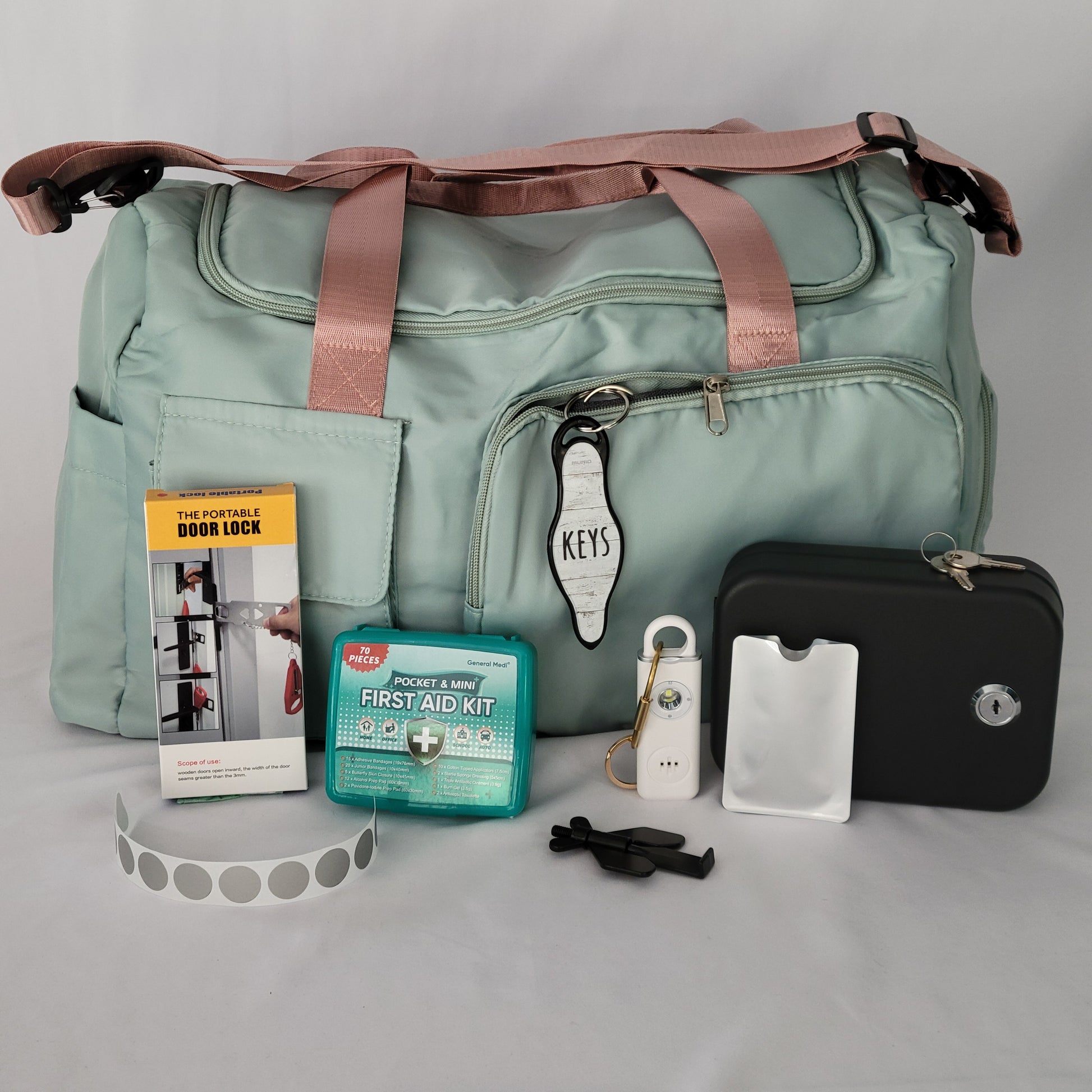 Women's Travel Safety Essentials Kit with a personal alarm, alarms and locks, and other key items for secure travels.