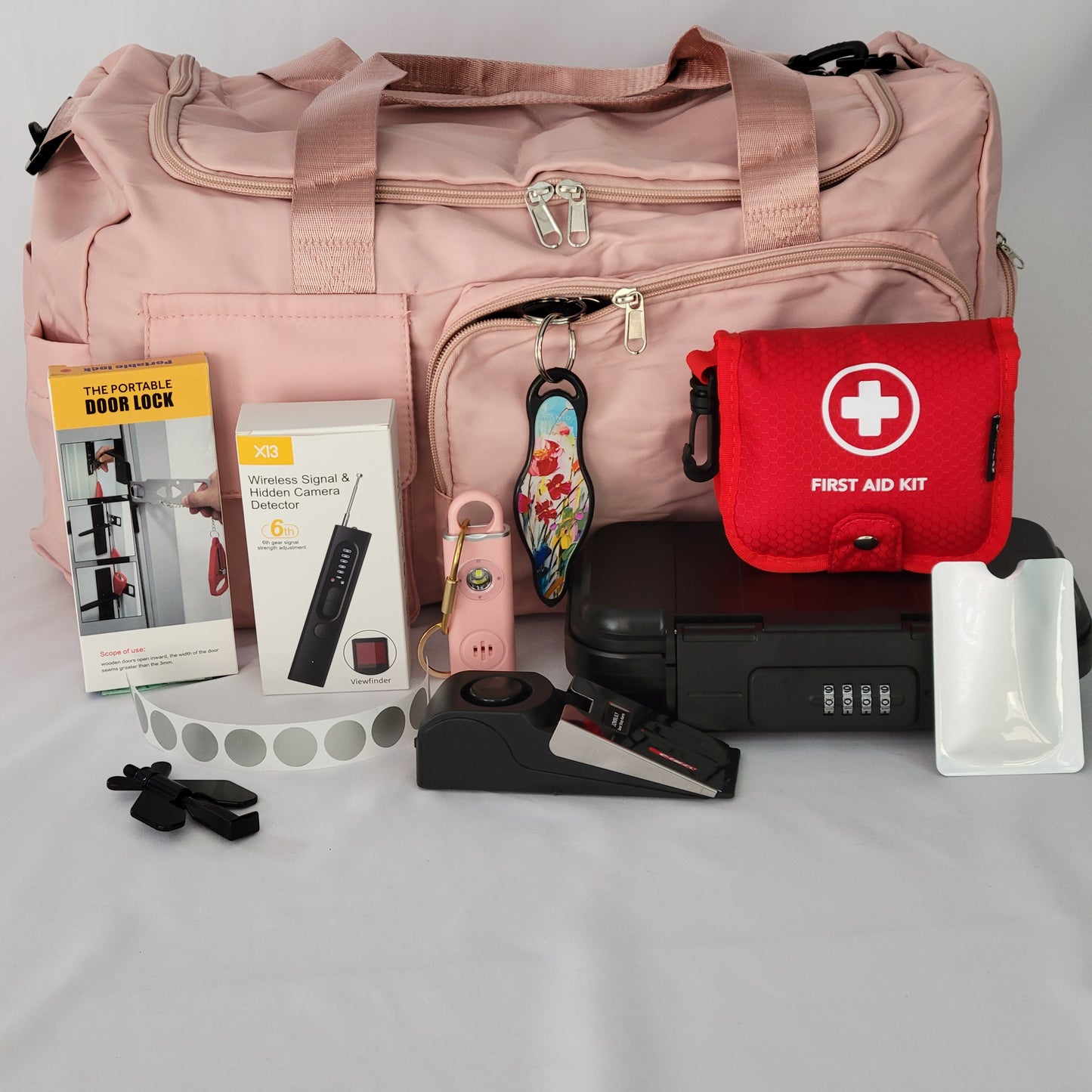 Women's Travel Safety Deluxe Kit with a personal alarm, alarms and locks, and other key items for secure travels.