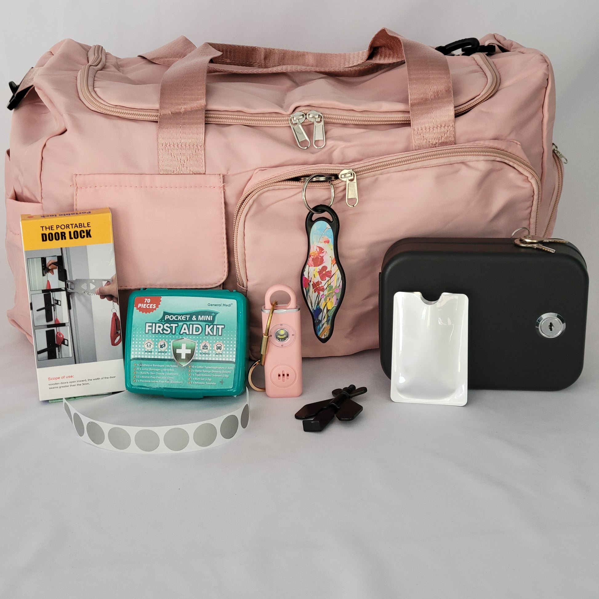 Women's Travel Safety Essentials Kit with a personal alarm, alarms and locks, and other key items for secure travels.